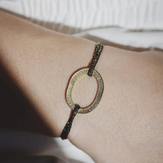 bracelet en cordon élastique irisé noir et sa pièce de 10 francs dorée